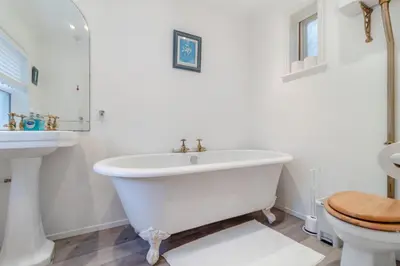 a white bathroom with a tub and a toilet at 2 Bed in Felixstowe oc-m30281 in Felixstowe