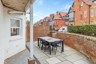 a patio with a table and chairs on a brick wall at 2 Bed in Felixstowe oc-m30281 in Felixstowe