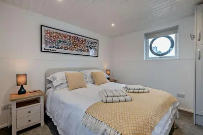 a bedroom with a large bed and a window at 1 Bed in Woodbridge oc-s30322 in Woodbridge
