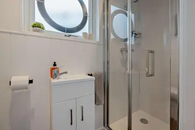 a bathroom with a shower and a sink and a mirror at 1 Bed in Woodbridge oc-s30322 in Woodbridge