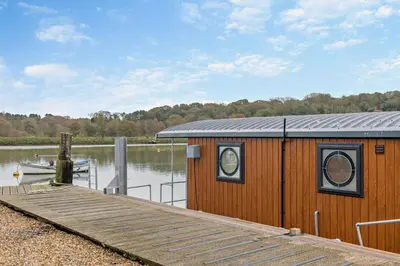 a wooden cabin with a dock on a lake at 1 Bed in Woodbridge oc-s30322 in Woodbridge