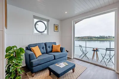 a living room with a blue couch and a large window at 1 Bed in Woodbridge oc-s30322 in Woodbridge