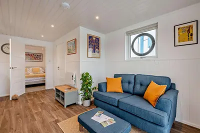 a living room with a blue couch and a bedroom at 1 Bed in Woodbridge oc-s30322 in Woodbridge