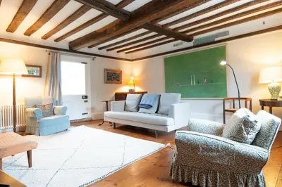 a living room with two chairs and a green chalkboard at River House in Kersey