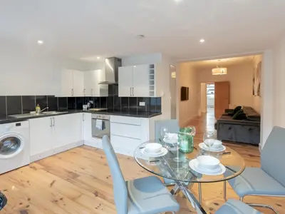a kitchen and dining room with a glass table and chairs at Cosy flat in Leigh - Pass the Keys in Southend-on-Sea
