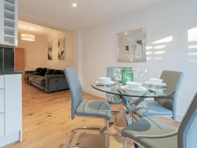 a dining room with a glass table and chairs at Cosy flat in Leigh - Pass the Keys in Southend-on-Sea