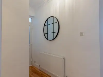 a mirror on a white wall in a room at Cosy flat in Leigh - Pass the Keys in Southend-on-Sea