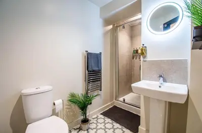 a bathroom with a toilet and a sink at Thetford Hive - Premium Self Check-In Aparthotel in Thetford