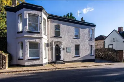 a white brick house on the side of a street at Thetford Hive - Premium Self Check-In Aparthotel in Thetford