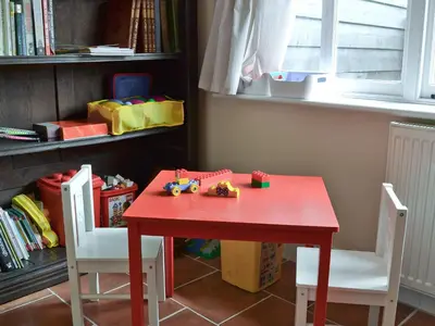 a red table with toy cars on top of it at Rose Farm Barn in Laxfield
