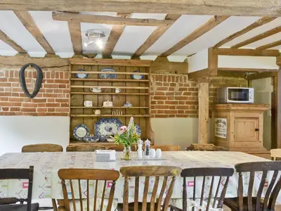 a dining room with a table and chairs at Rose Farm Barn in Laxfield