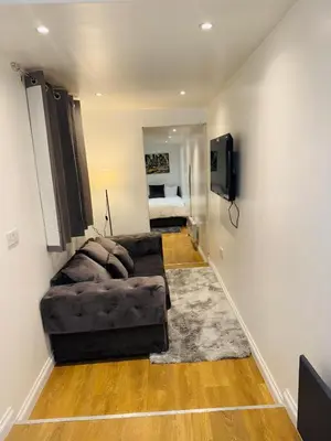 a living room with a couch and a television at M18 Escape in Havering atte Bower