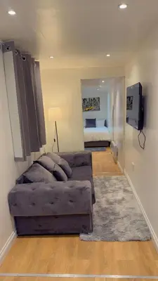a living room with a couch and a bedroom at M18 Escape in Havering atte Bower