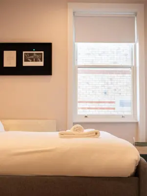 a bed in a room with a window at Modern 1Bed Apartment supercentral in Cambridge