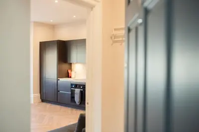 a kitchen with black cabinets and a stove at Modern 1Bed Apartment supercentral in Cambridge