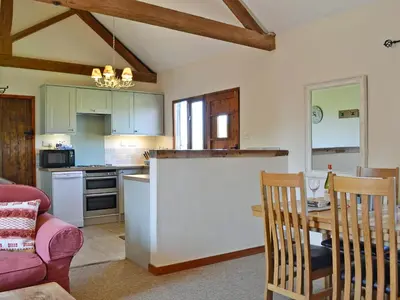 a kitchen and dining room with a table and chairs at The Cart Shed - E1768 in Westleton