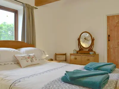 a bedroom with a bed with towels on it at The Wood Shed - E1919 in Westleton