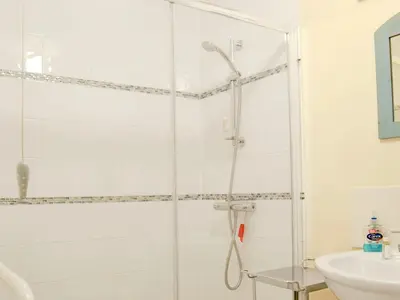 a shower with a glass door in a bathroom at The Wood Shed - E1919 in Westleton