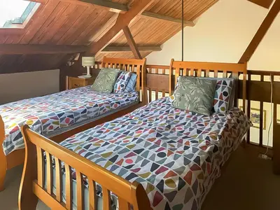 a bedroom with two beds in a attic at Swan in Welney