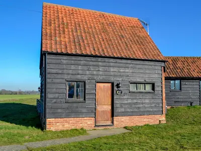 a small house with a brown door and a red roof at Sally's Nest - E3042 in Blyford