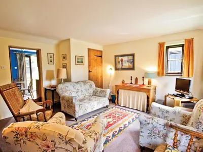 a living room with a couch and a chair at The Stables - E3491 in Saxtead