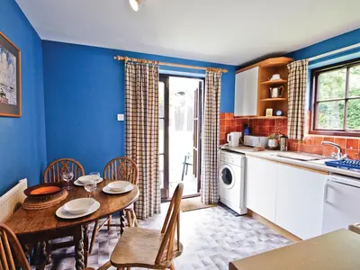 a kitchen with a table and a dining room at The Stables - E3491 in Saxtead