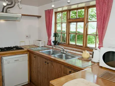 a kitchen with a sink and a window at Field Cottage in Sudbourne