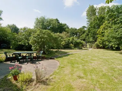 a picnic table and chairs in a park at Field Cottage in Sudbourne
