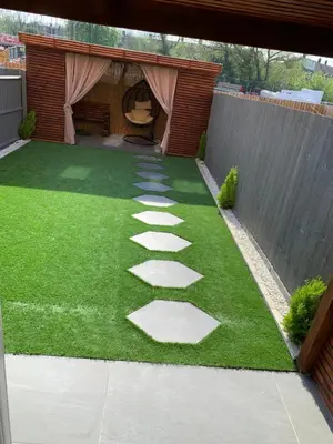 a garden with stepping stones on the grass at BYK Homes, Hotels and Suites in Grays Thurrock