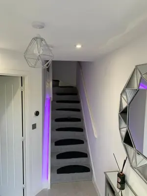 a spiral staircase in a house with purple lighting at BYK Homes, Hotels and Suites in Grays Thurrock