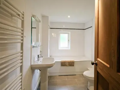 a bathroom with a sink and a toilet and a window at The Station - E5336 in Wetheringsett