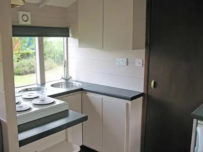 a small kitchen with a sink and a stove at Railway Carriage One - E5337 in Wetheringsett