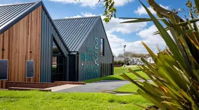 a black house with a painting on the side of it at Marie Helene, 58 Mallard Carlton Meres Holiday Park in Kelsale