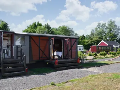 a tiny house sitting on the side of a road at The Guards Van in Wetheringsett