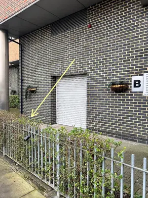 a building with a garage door with a bug on it at Serenity-ESE Entire Home in Basildon