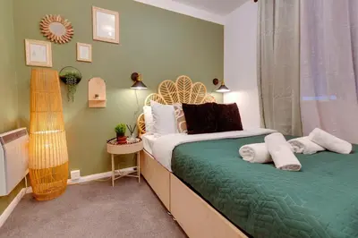 a bedroom with a bed with towels on it at Stylish and modern studio flat Free parking - Pass the Keys in Cambridge