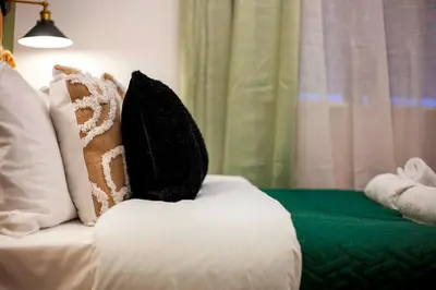 a white couch with two pillows on top of it at Stylish and modern studio flat Free parking - Pass the Keys in Cambridge