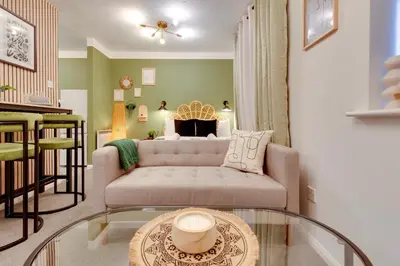 a living room with a couch and a table at Stylish and modern studio flat Free parking - Pass the Keys in Cambridge