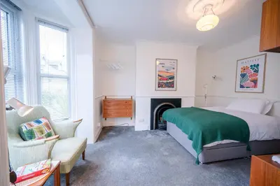 a bedroom with a bed and a fireplace at Lower Cedars, Saxmundham in Saxmundham