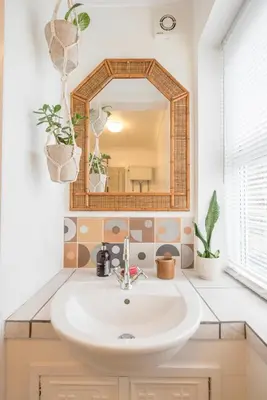 a bathroom with a sink and a mirror at Lower Cedars, Saxmundham in Saxmundham