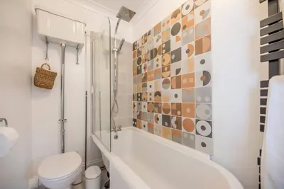 a bathroom with a tub and a toilet and a shower at Lower Cedars, Saxmundham in Saxmundham