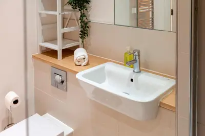 a bathroom with a sink and a mirror at 54 Woodpecker Way · Modern apartment near Addenbrookes Free parking Pass the Keys in Cambridge