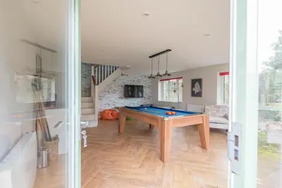 a room with a ping pong table in it at Buoys Cottage, Orford in Orford