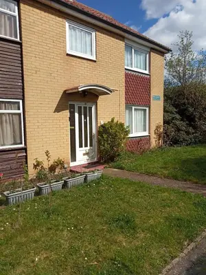 a house with a front door and some plants at Comfortable holiday home in Basildon Essex in Laindon