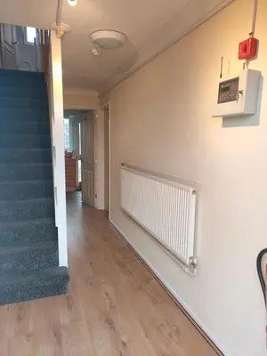 an empty hallway with a staircase and a blue carpet at Comfortable holiday home in Basildon Essex in Laindon
