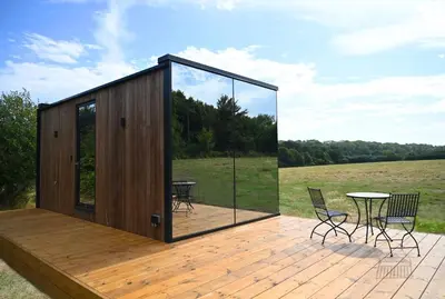a wooden deck with a table and chairs on it at Mirror Houses Pound Farm - Meadow OOD in Saxmundham