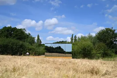 a glass house on a road in a field at Mirror Houses Pound Farm - Meadow OOD in Saxmundham