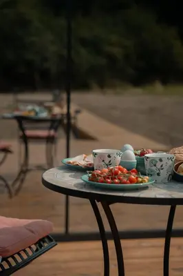 a table with plates of food and cups on it at Mirror Houses Pound Farm - Meadow OOD in Saxmundham