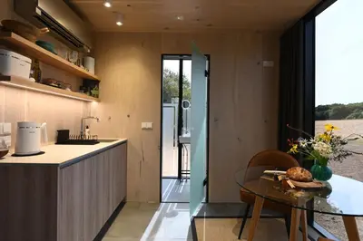 a kitchen and dining room with a glass table at Mirror Houses Pound Farm - Pond OOD in Saxmundham