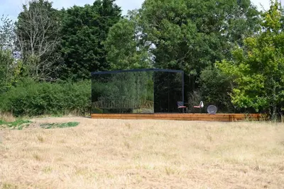 a glass house in the middle of a field at Mirror Houses Pound Farm - Pond OOD in Saxmundham